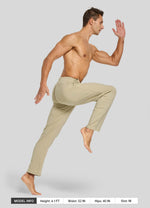 Man in casual cotton pants performing a running pose 
