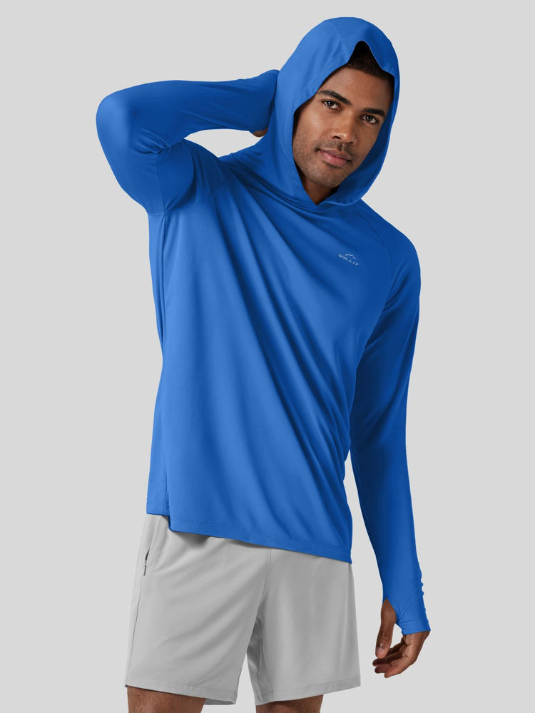 A man wearing a bright blue long-sleeve hooded athletic shirt and light gray shorts 