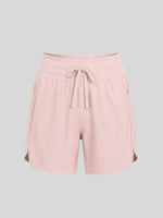 Women's light pink athletic shorts with a drawstring waist, side pockets, and side gussets 