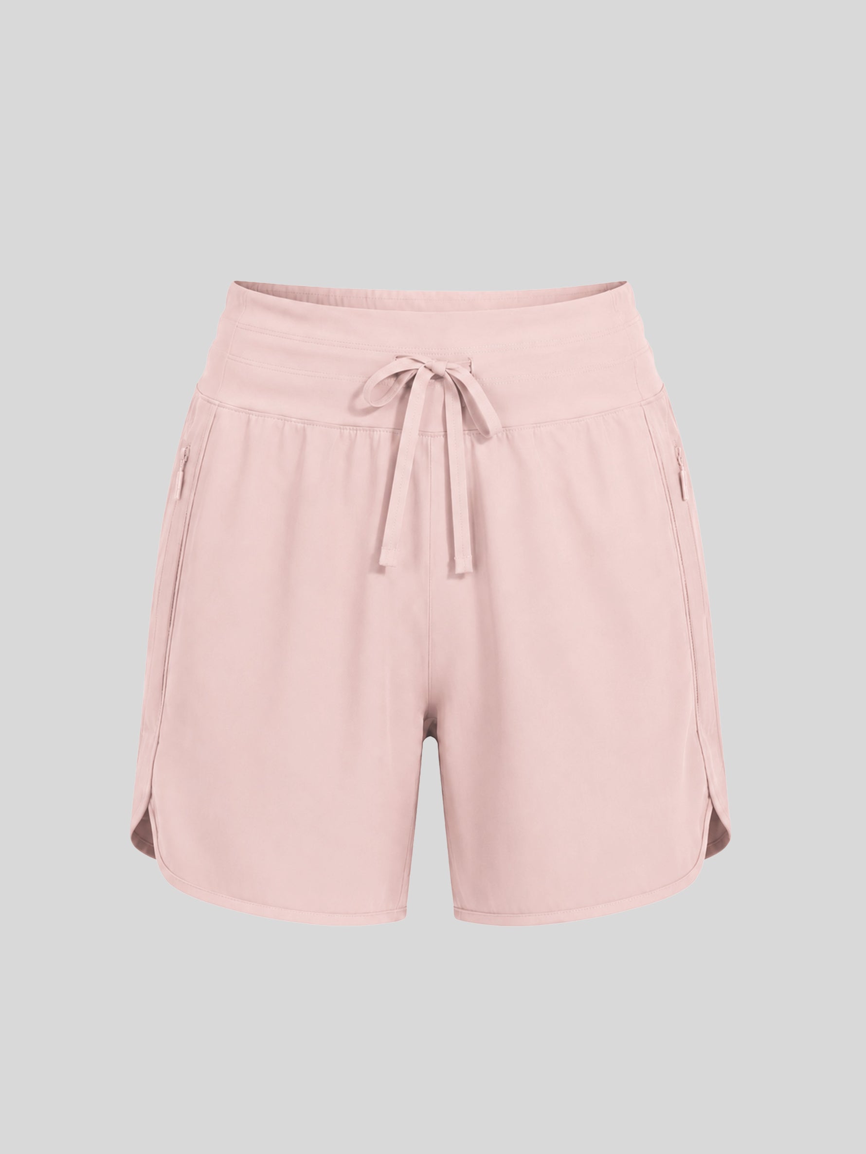 Women's light pink athletic shorts with a drawstring waist, side pockets, and side gussets 