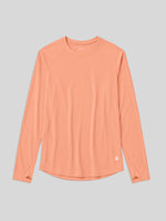 A peach-colored long-sleeve athletic top with a crew neck, laid flat 