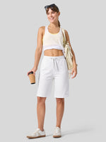 A woman modeling white drawstring cotton bermuda shorts 