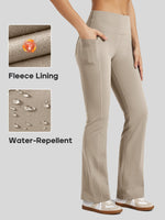 A woman wears beige high-waisted flared fleece leggings with side pockets 