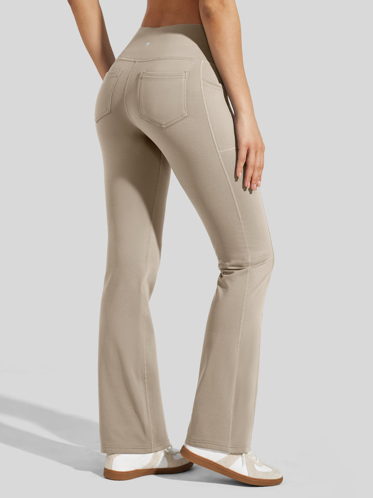 back view of beige high-waisted flared fleece leggings 