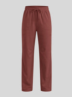 A pair of brick red pants with an elastic drawstring waist and side pockets 