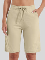 women wearing light beige drawstring cotton bermuda shorts with side pockets 
