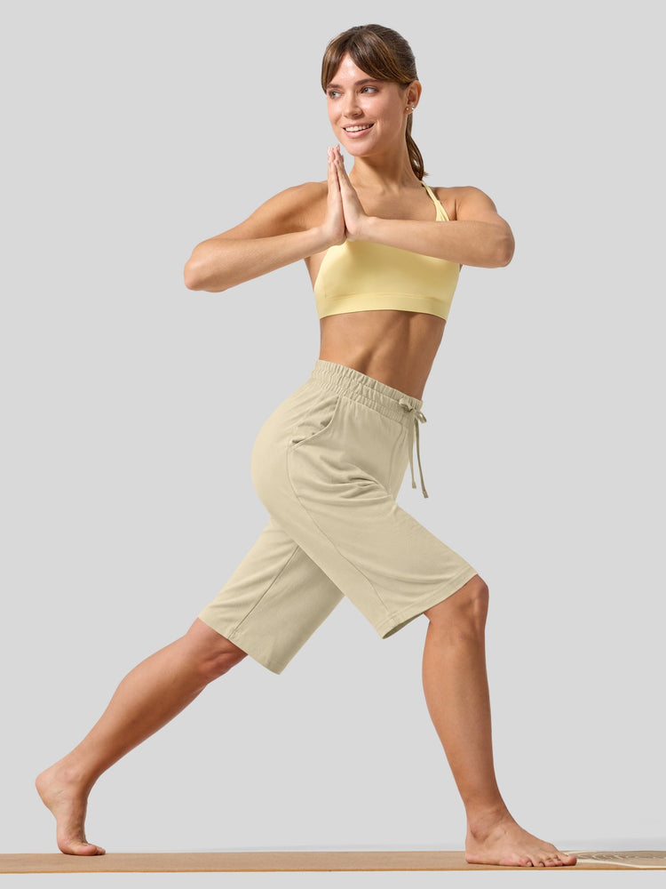 women wearing light beige drawstring cotton bermuda shorts with side pockets 