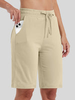 women wearing light beige drawstring cotton bermuda shorts with side pockets 