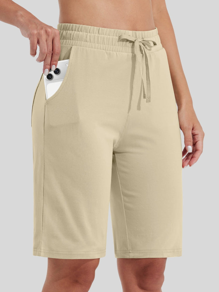 women wearing light beige drawstring cotton bermuda shorts with side pockets 