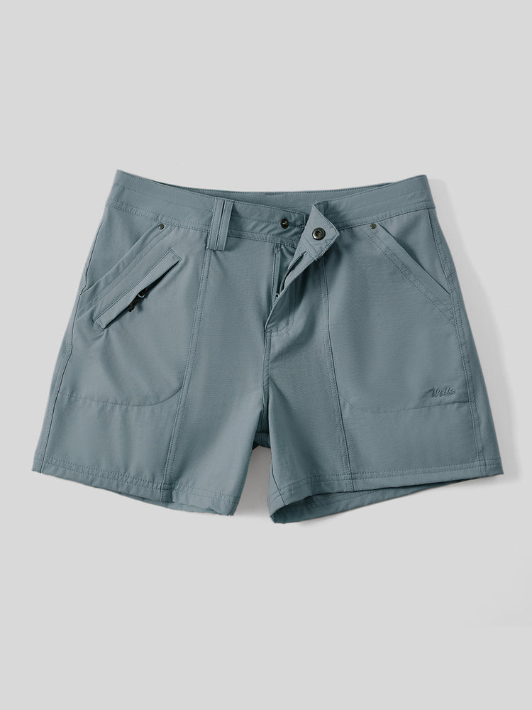 A pair of women's slate blue outdoor shorts with a button closure, zippered side pockets  