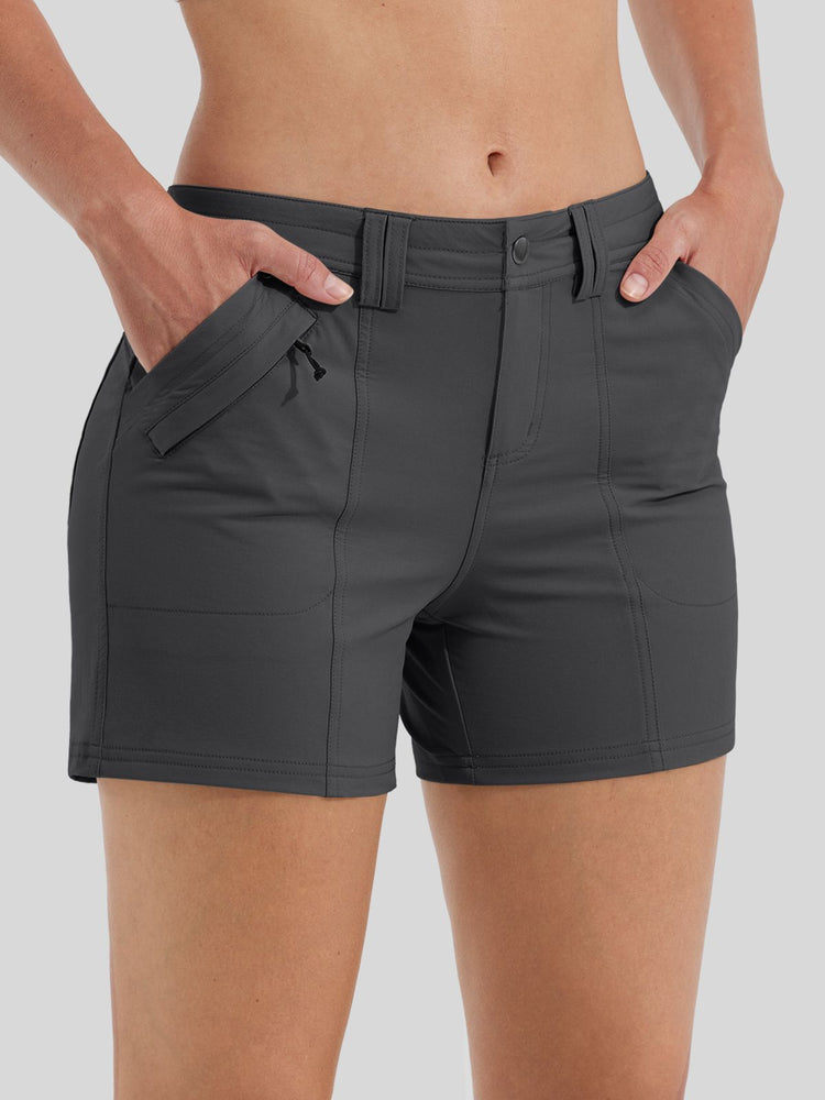 A close-up of a woman's dark gray athletic shorts with side zippered pockets 