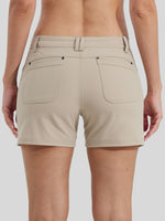 Rear view of a woman model wearing beige high-waisted shorts with two large back patch pockets and a belt loop 
