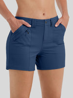 A close-up of a model wearing navy blue athletic shorts with side pockets 