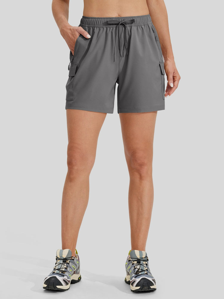 A model wearing gray athletic shorts with side cargo pockets and a drawstring waist  
