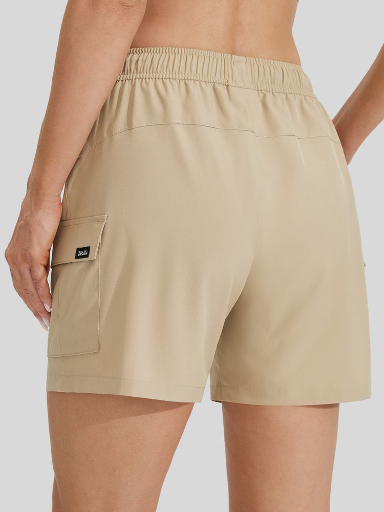 Beige cargo shorts with an elastic waistband, shown on a model from the back. The shorts feature a side cargo pocket with WILLIT brand tag. 