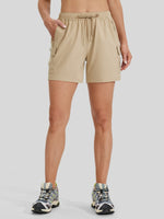 A model wearing beige cargo shorts with an elastic drawstring waist and side cargo pockets 