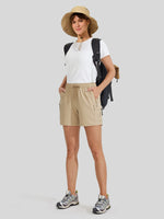 A woman modeling a white short-sleeve t-shirt, beige cargo shorts 