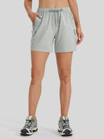A model wearing light gray athletic cargo shorts with a drawstring waistband and side cargo pockets front view 