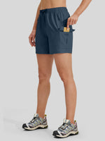 A model wearing navy blue athletic shorts with a side cargo pocket 