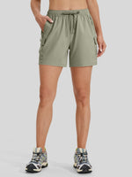 A model from the waist down wearing sage green cargo shorts with a drawstring waistband 
