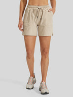 women wearing beige athletic shorts with a drawstring waist and side pockets 