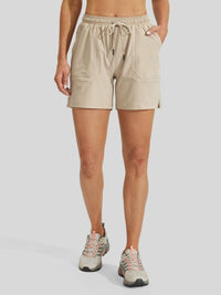women wearing beige athletic shorts with a drawstring waist and side pockets #khaki