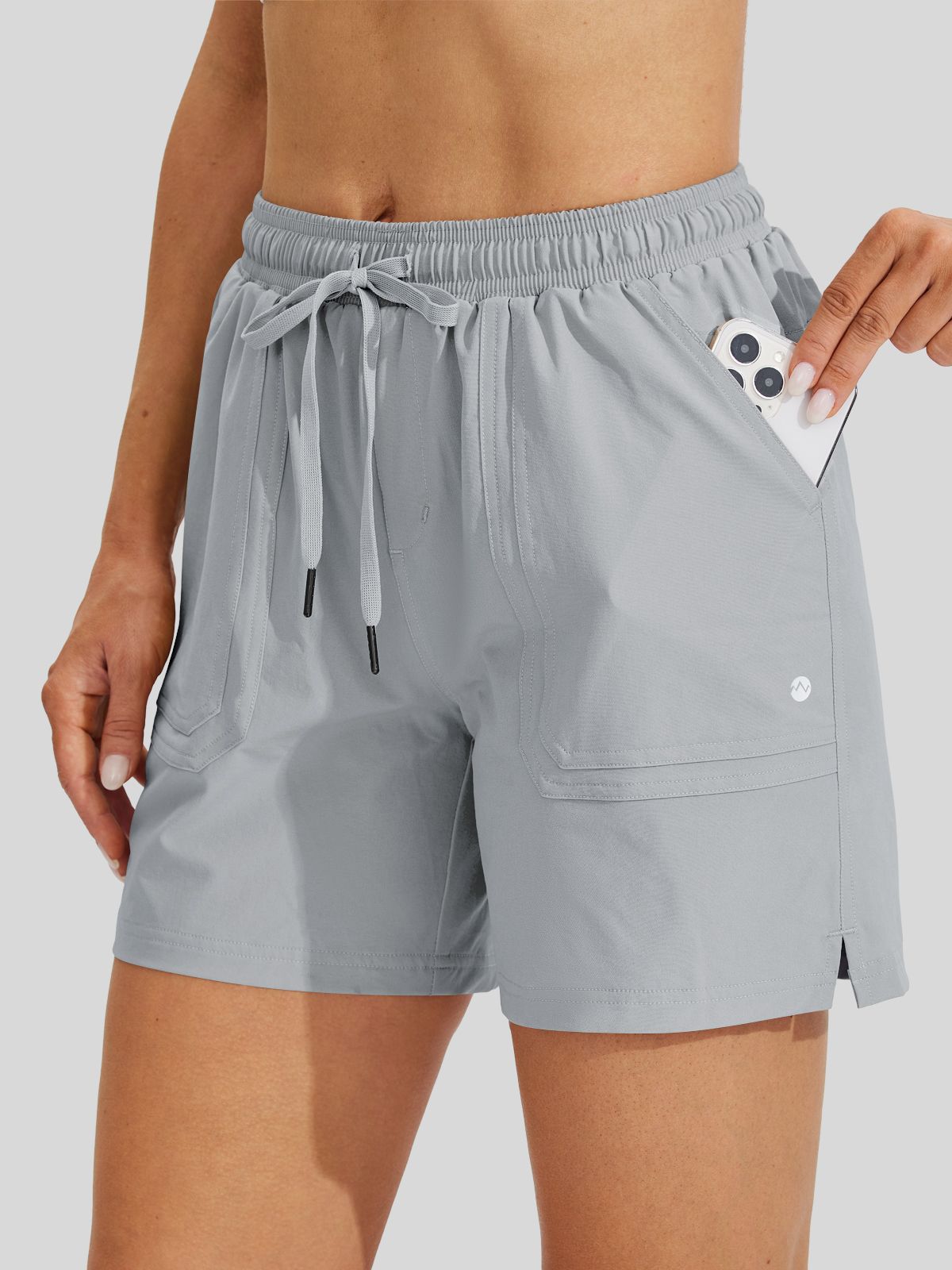 Light gray athletic shorts with an elastic drawstring waist and side pockets 