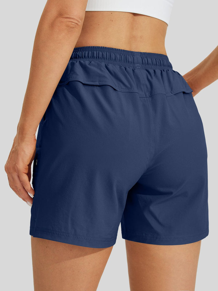 A close-up back view of women wearing lightweight hiking athletic shorts with an elastic waistband 