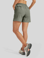 A model from the waist down wearing lightweight drawstring shorts back-view 