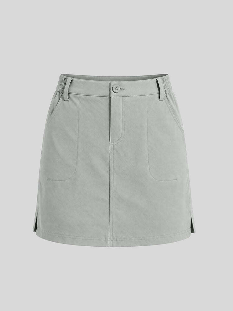 A light gray utility mini skirt with a button closure, belt loops, and front pockets 