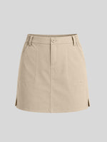 A beige utility-style mini skirt with a button closure, belt loops, front pockets, and side slits 
