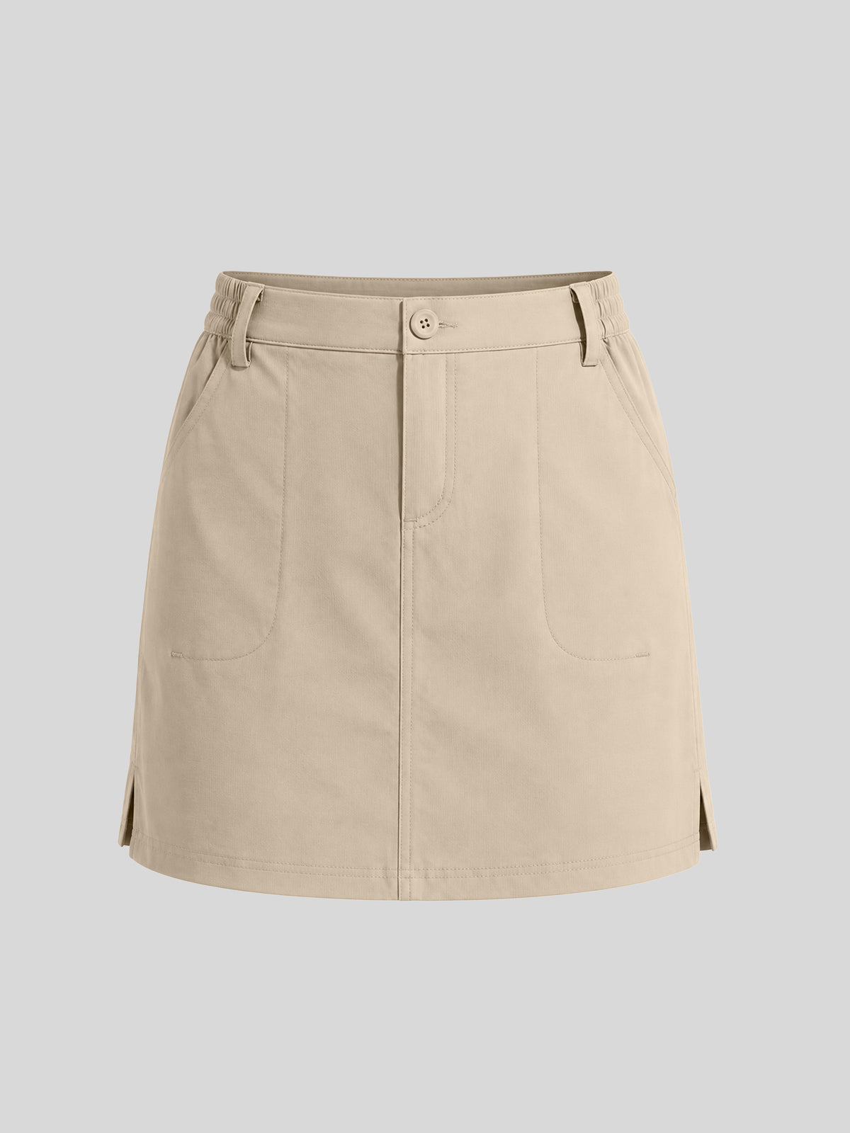 A beige utility-style mini skirt with a button closure, belt loops, front pockets, and side slits 
