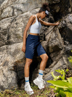 A woman wearing navy athletic shorts_Women's Outdoor Cargo Shorts 10 Inch 