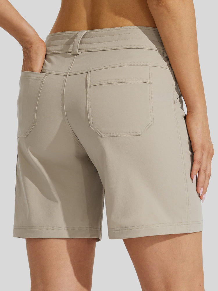 Back view of a woman wearing light beige utility shorts with a waistband, side pockets, and a back pocket 
