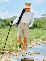 A woman hiking outdoors in a rocky stream, wearing willit beige cargo shorts 