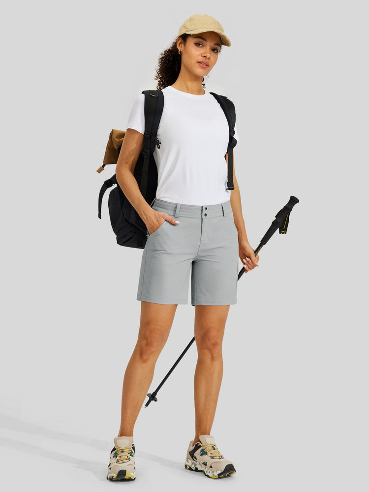 A woman modeling light gray hiking shorts 