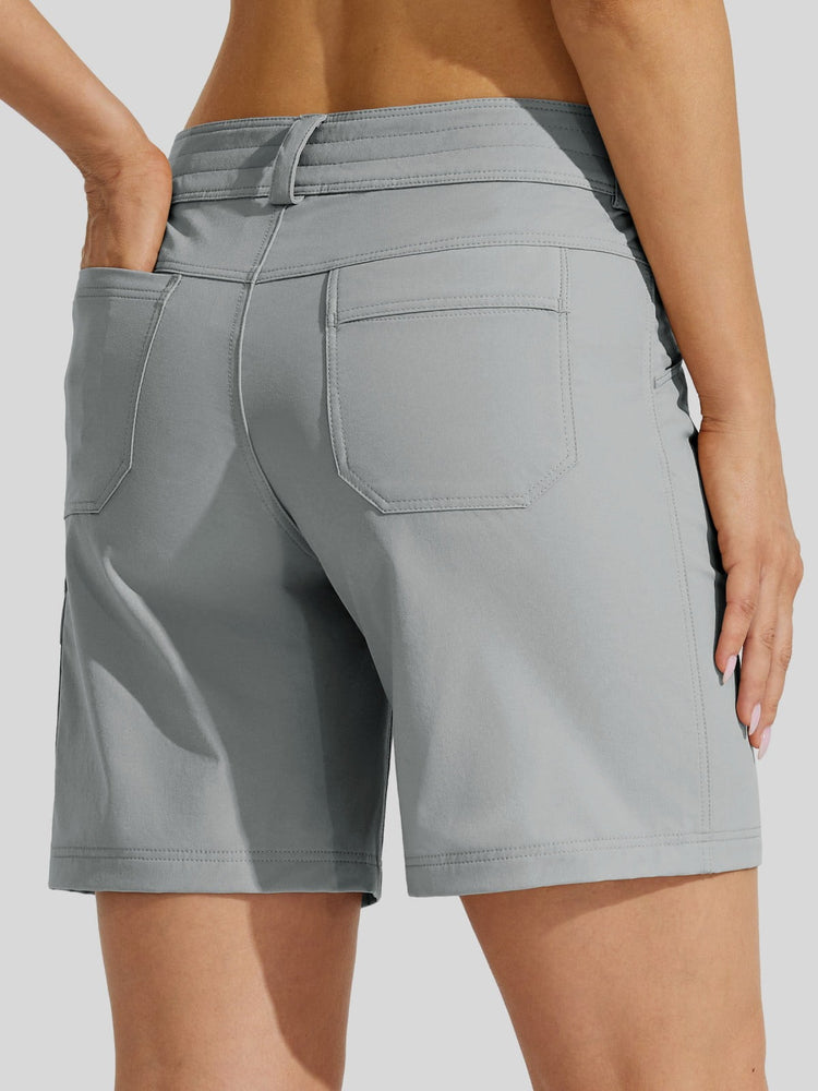 A close-up back view of a woman wearing light gray athletic shorts with a side waistband, back pockets, and a relaxed fit 