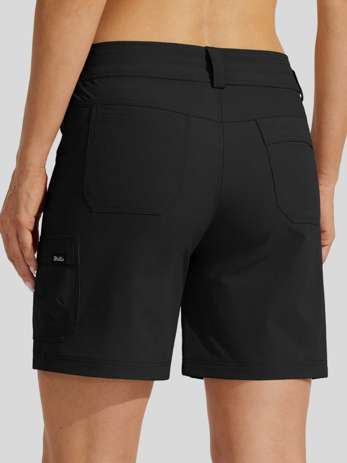 Rear view of a woman wearing black cargo shorts with a belt loop and side cargo pocket, 