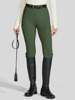 Person wearing green equestrian pants and black riding boots 