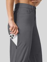 Close-up of a model wearing dark gray wide-leg trousers, showing a side pocket holding a white smartphone. 