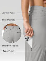 Close-up of a woman wearing light gray athletic pants, showing side and back pockets with overlaid labels: Mini Coin Pocket, 2 Hand Pockets, 2 Flap Back Pockets, and 1 Zipper Pocket. A phone is partially inserted into the side pocket. 